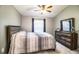 Cozy bedroom with a queen bed, dresser with mirror, and window at 3882 Rollingsford Cir, Lakeland, FL 33810