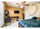 Comfortable bedroom featuring a bed with desk, a ceiling fan, and fun decor at 3882 Rollingsford Cir, Lakeland, FL 33810