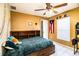 Cozy bedroom features a bed with storage, ceiling fan, and fun decor at 3882 Rollingsford Cir, Lakeland, FL 33810