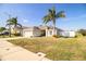 Charming single-story home boasting a well-manicured lawn, palm trees, and a bright exterior paint scheme at 3882 Rollingsford Cir, Lakeland, FL 33810