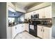 Kitchen featuring stainless steel appliances, granite countertops, white cabinets and tile floors at 3882 Rollingsford Cir, Lakeland, FL 33810