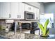 Close-up of bright kitchen featuring granite countertops, stainless steel appliances, and stylish white cabinetry at 3882 Rollingsford Cir, Lakeland, FL 33810