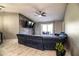 Spacious living room with ceiling fan, tile floors, stone accent wall, and sliding glass doors at 3882 Rollingsford Cir, Lakeland, FL 33810