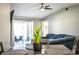 Living room area with vaulted ceilings, ceiling fan, and sliding glass doors at 3882 Rollingsford Cir, Lakeland, FL 33810