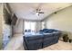 Bright living room with a large sectional, a decorative fireplace, and access to the patio at 3882 Rollingsford Cir, Lakeland, FL 33810