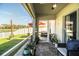 Enclosed patio filled with plants offering serene pond views in a fenced-in yard at 3882 Rollingsford Cir, Lakeland, FL 33810