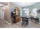 Bright dining area with a wooden table set for four, decorative accents, and laminate flooring at 4010 Winding Vine Dr # 4010, Lakeland, FL 33812