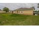 Well-maintained yellow home featuring a tidy lawn and classic architecture at 4010 Winding Vine Dr # 4010, Lakeland, FL 33812