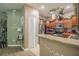 Well-lit kitchen featuring granite counters, stainless steel appliances, and decorative hanging pot rack at 4010 Winding Vine Dr # 4010, Lakeland, FL 33812