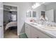 Bright bathroom featuring double sinks, white cabinets, tile flooring and decorative accents at 4010 Winding Vine Dr # 4010, Lakeland, FL 33812