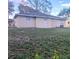 A view of the back of the house showing a patio and landscaping at 406 Fox Lake Dr, Lakeland, FL 33809