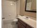 Bathroom with a shower-tub combo, toilet, and single sink vanity at 406 Fox Lake Dr, Lakeland, FL 33809