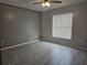 Spacious bedroom features tile flooring, a window, and gray walls at 406 Fox Lake Dr, Lakeland, FL 33809