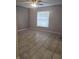 Bedroom featuring neutral walls, ceiling fan, and a bright window at 406 Fox Lake Dr, Lakeland, FL 33809