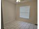Vacant bedroom with light walls, window, and tile flooring at 406 Fox Lake Dr, Lakeland, FL 33809