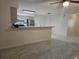 Bright kitchen features gray cabinets, stainless steel appliances, breakfast bar, and light tile flooring at 406 Fox Lake Dr, Lakeland, FL 33809