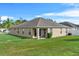 A view of the home from the backyard showcasing ample green space and the exterior of the house at 4688 Hickory Stream Ln, Mulberry, FL 33860