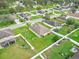 Aerial view of a home with a large, fenced backyard with lush green grass and playground equipment at 4688 Hickory Stream Ln, Mulberry, FL 33860