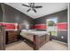 Well-lit bedroom with carpet, gray and red accent wall, large window, and ceiling fan at 4688 Hickory Stream Ln, Mulberry, FL 33860