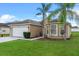 Street view of a well-maintained single Gathering home with a manicured lawn and lovely shrubbery at 4688 Hickory Stream Ln, Mulberry, FL 33860