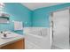 Bright bathroom featuring dual sinks, a separate shower, a soaking tub, and sleek fixtures at 4688 Hickory Stream Ln, Mulberry, FL 33860