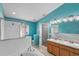 Bright bathroom featuring dual sinks, a separate shower, a soaking tub, and sleek fixtures at 4688 Hickory Stream Ln, Mulberry, FL 33860