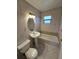 Tiled bathroom featuring a pedestal sink, toilet, and a combined bathtub and shower with a window at 475 W Ethelene St, Bartow, FL 33830