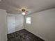 Bedroom featuring dark wood-look floors, a ceiling fan, and a window at 475 W Ethelene St, Bartow, FL 33830