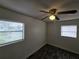 Bedroom with dark wood-look floors, ceiling fan, and natural light from windows at 475 W Ethelene St, Bartow, FL 33830