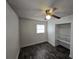 Bedroom features dark wood-look floors, a ceiling fan, a closet, and a window at 475 W Ethelene St, Bartow, FL 33830