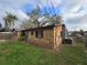 Side exterior featuring stone accents and a well-maintained lawn with lush landscaping at 475 W Ethelene St, Bartow, FL 33830