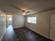 View of the living room with hardwood floors, ceiling fan, and access to other rooms in the home at 475 W Ethelene St, Bartow, FL 33830