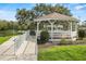 A community gazebo offers a shaded retreat with views of the lake and walking paths at 4911 Colonnades Club Blvd, Lakeland, FL 33811