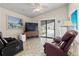 Living room featuring recliner chairs, tiled floor, and sliding door access to the outside at 4911 Colonnades Club Blvd, Lakeland, FL 33811