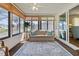 Relaxing sun room featuring a comfortable sofa, area rug, and expansive windows for natural light at 4911 Colonnades Club Blvd, Lakeland, FL 33811