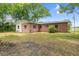 Rear exterior view of a brick home with a well-maintained yard and ample space at 507 8Th Se St, Fort Meade, FL 33841