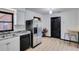 This kitchen features stainless steel appliances, white cabinetry, and tile flooring at 507 8Th Se St, Fort Meade, FL 33841