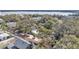 Aerial view of a home surrounded by lush greenery and a scenic lake at 511 Mcrorie St, Lakeland, FL 33803