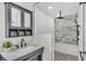 A bathroom featuring gray stone pebble floor and rain shower with gray stone wall and white subway tile at 511 Mcrorie St, Lakeland, FL 33803