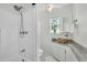 Bright bathroom featuring walk-in shower, white tub, granite countertop, and bowl sink at 511 Mcrorie St, Lakeland, FL 33803