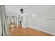 Hardwood floors, ceiling fan, and mirrored sliding closet in this spacious bedroom at 511 Mcrorie St, Lakeland, FL 33803