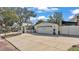 Home featuring an attached garage, a paved driveway and a charming white picket fence at 511 Mcrorie St, Lakeland, FL 33803