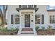 Charming home facade with dark shutters, a classic door, and a well-manicured garden at 511 Mcrorie St, Lakeland, FL 33803