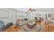 Cozy living room featuring a sofa, hardwood floors, and an open layout to the dining area at 511 Mcrorie St, Lakeland, FL 33803