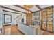 Bright living room featuring hardwood floors, exposed ceiling beams, a cozy fireplace, and elegant built-in shelving at 511 Mcrorie St, Lakeland, FL 33803