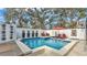 Pool featuring a swim-up bar, a tanning deck, and lush tropical landscaping at 511 Mcrorie St, Lakeland, FL 33803