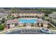 Aerial view of community pool, pool house, and lounge chairs surrounded by mature palm trees at 5377 Quarry Rock Rd, Lakeland, FL 33809