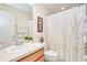 Well-lit bathroom featuring a decorative shower curtain, neutral color palette, and a sink at 5377 Quarry Rock Rd, Lakeland, FL 33809