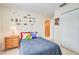 Neat bedroom with cartoon decorations, wooden drawers, and a double door closet at 5377 Quarry Rock Rd, Lakeland, FL 33809