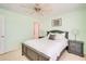 Bedroom showcasing a ceiling fan, light green walls, a queen bed, and natural lighting at 5377 Quarry Rock Rd, Lakeland, FL 33809